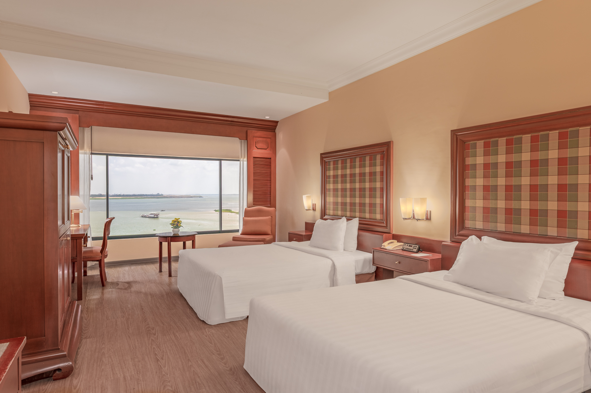 Hotel Cambodiana deluxe twin room with river view, hotel bedroom photography in Phnom Penh.